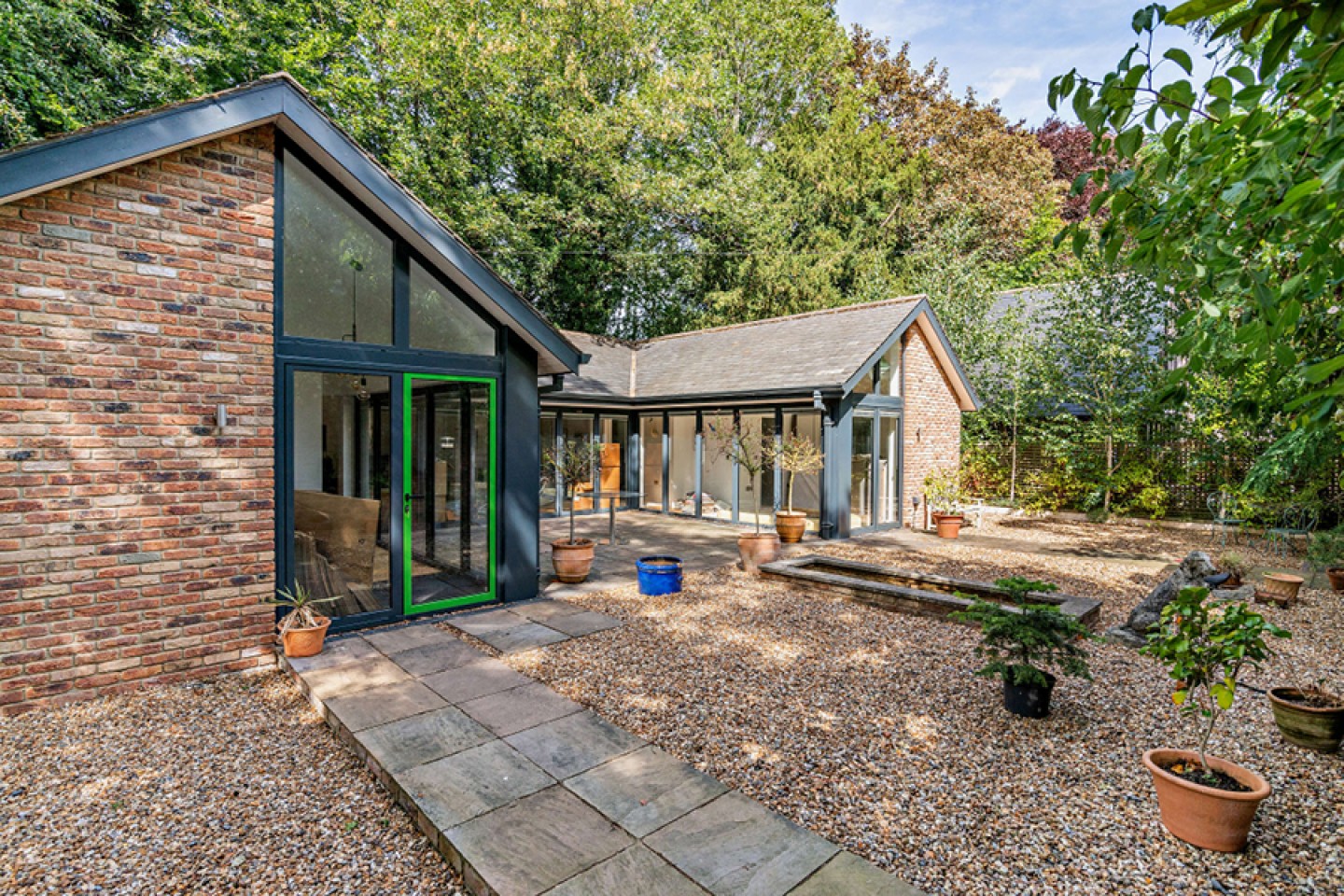 Detached single story brick annex with floor to ceiling windows